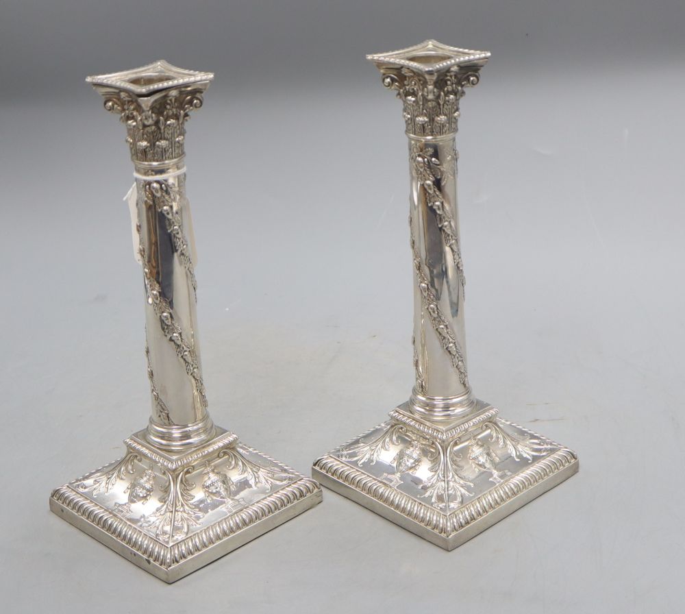 A pair of late Victorian silver candlesticks with acorn and urn decoration, Thomas Bradbury & Sons, London, 1898, 25cm, loaded,